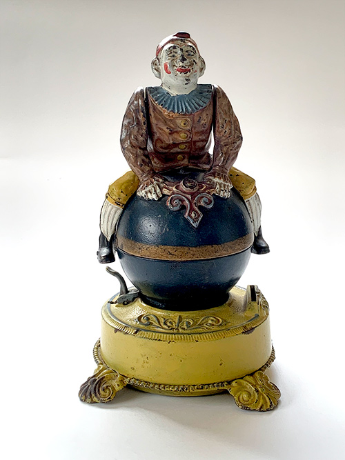 19th Century clown on globe mechanical bank with harder to find yellow base